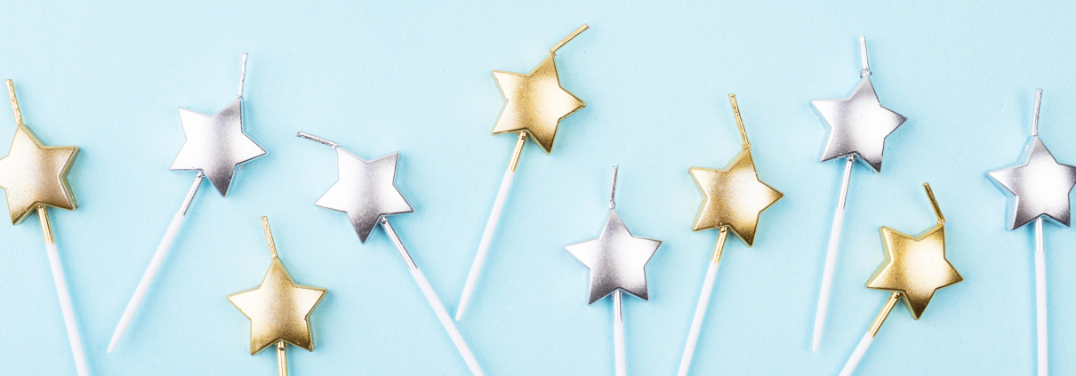 Top-down image of star-shaped birthday candles arranged for a celebration